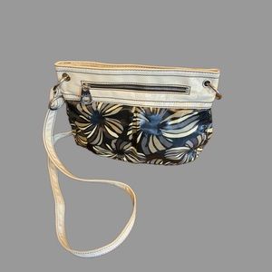Relic floral, print it with a shiny patent leather type area and strap.